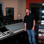 Chase standing with SSL console